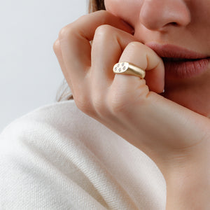 Model posing in Dana Bronfman Constellation Lipstick ring in yellow gold with white diamonds.